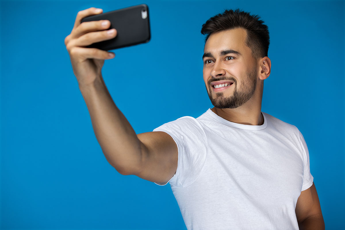 handsome american man takes selfie smiles camera